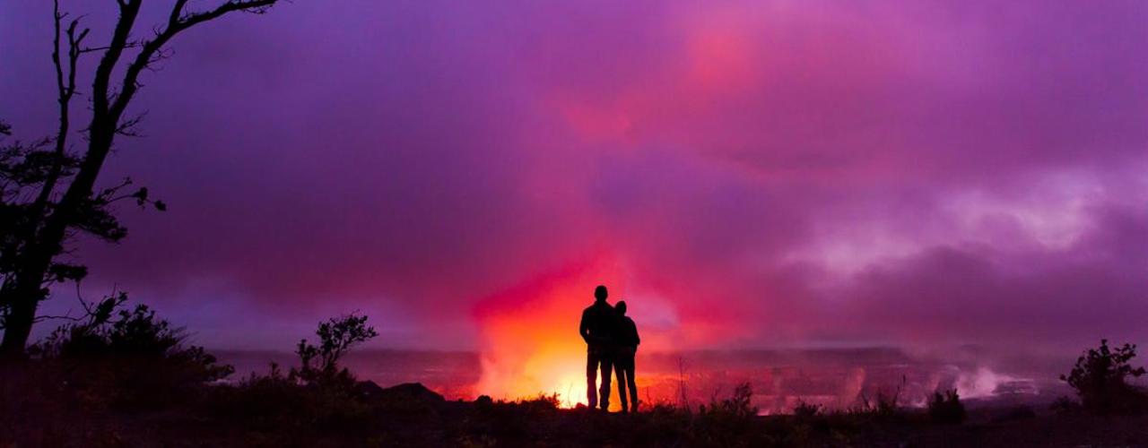 Hawaii Honeymoons and Anniversaries 3 003112 Couple overlooking Halemaumau Crater Hawaii Island 07194 Hawaii Tourist Board 001